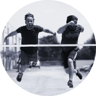 Two RAB2B teammates mid-stride competing in a Rabinolympics race